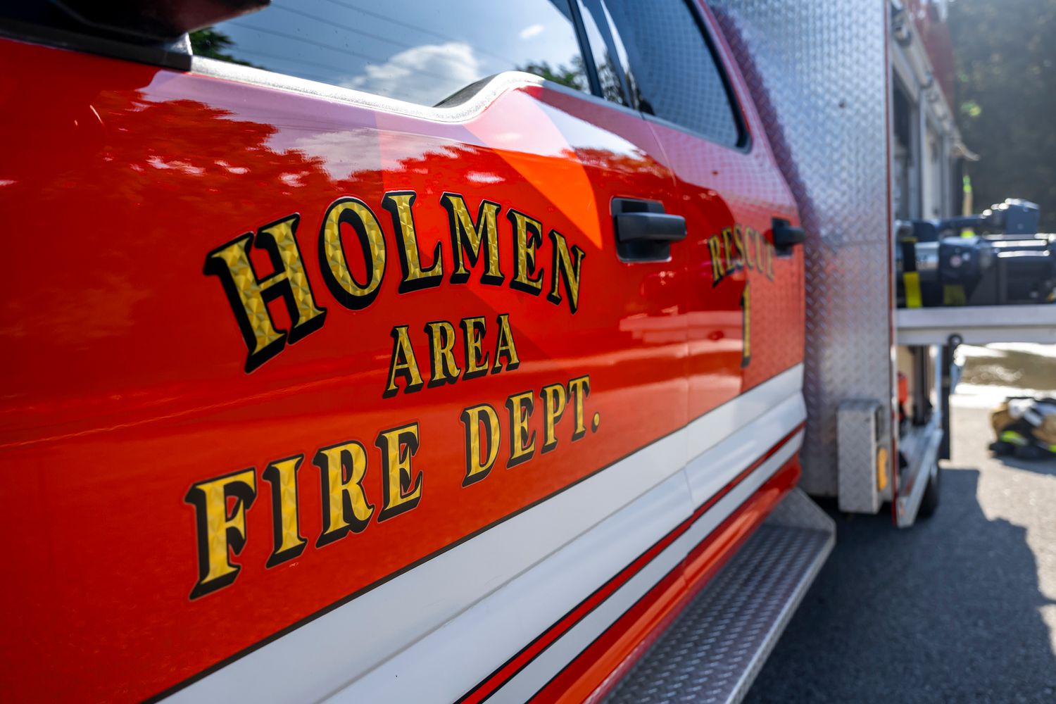 Close-up of red fire truck with Holmen Fire Department lettering on the side.