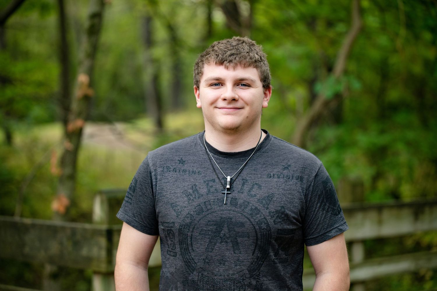 Outdoor portrait against lush green foliage background.