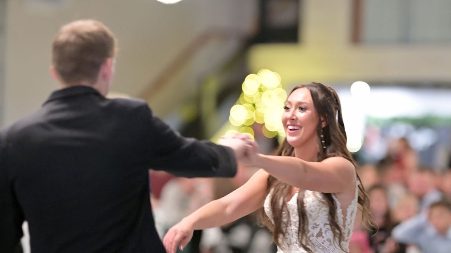 Wedding reception dance floor filled with joyful celebration and movement.