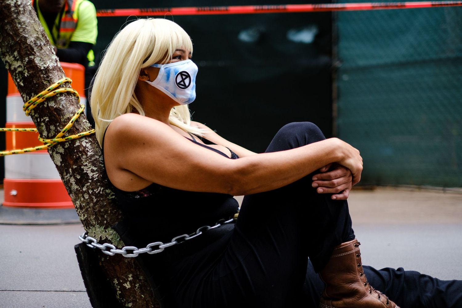 Female climate protestor chained to a tree