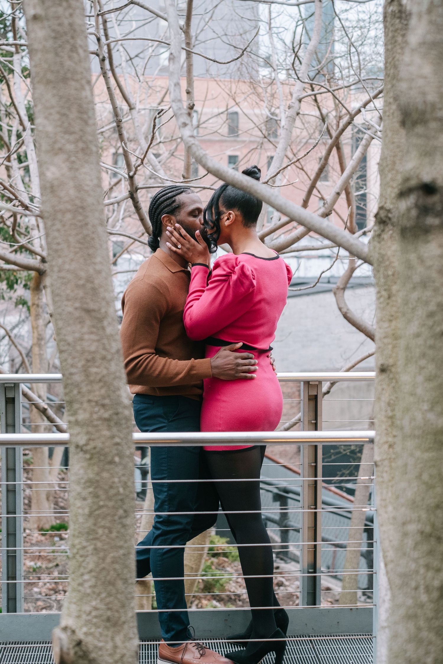 Recently engaged couple kissing on The High Line in New York City