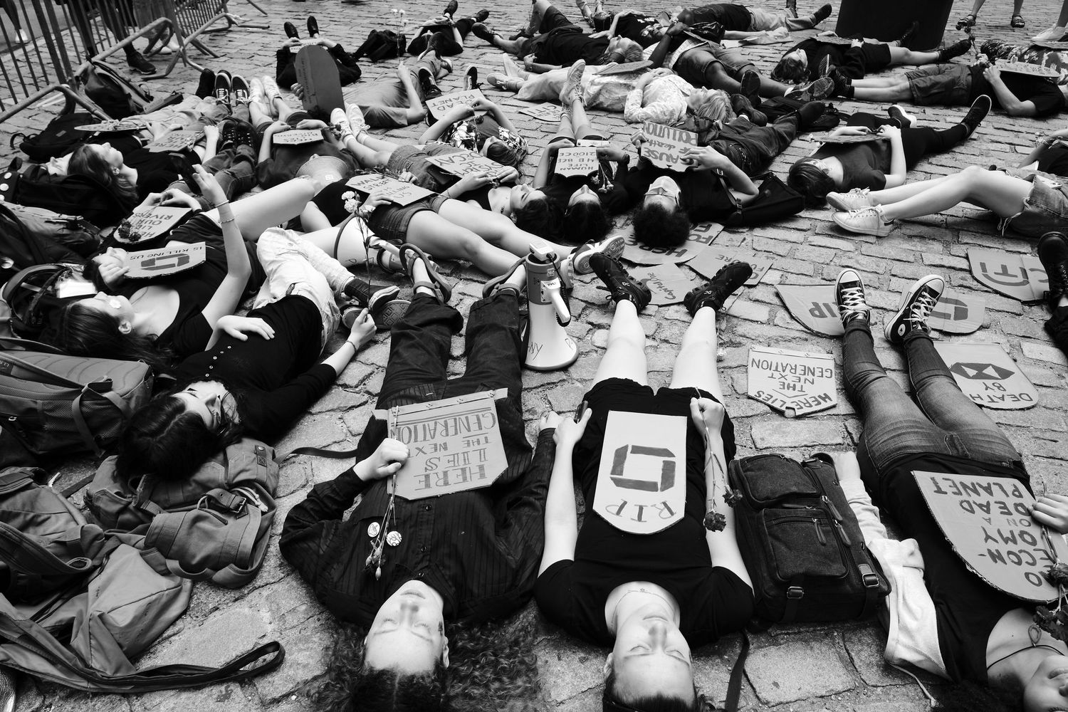 Young climate protestors lying on the ground