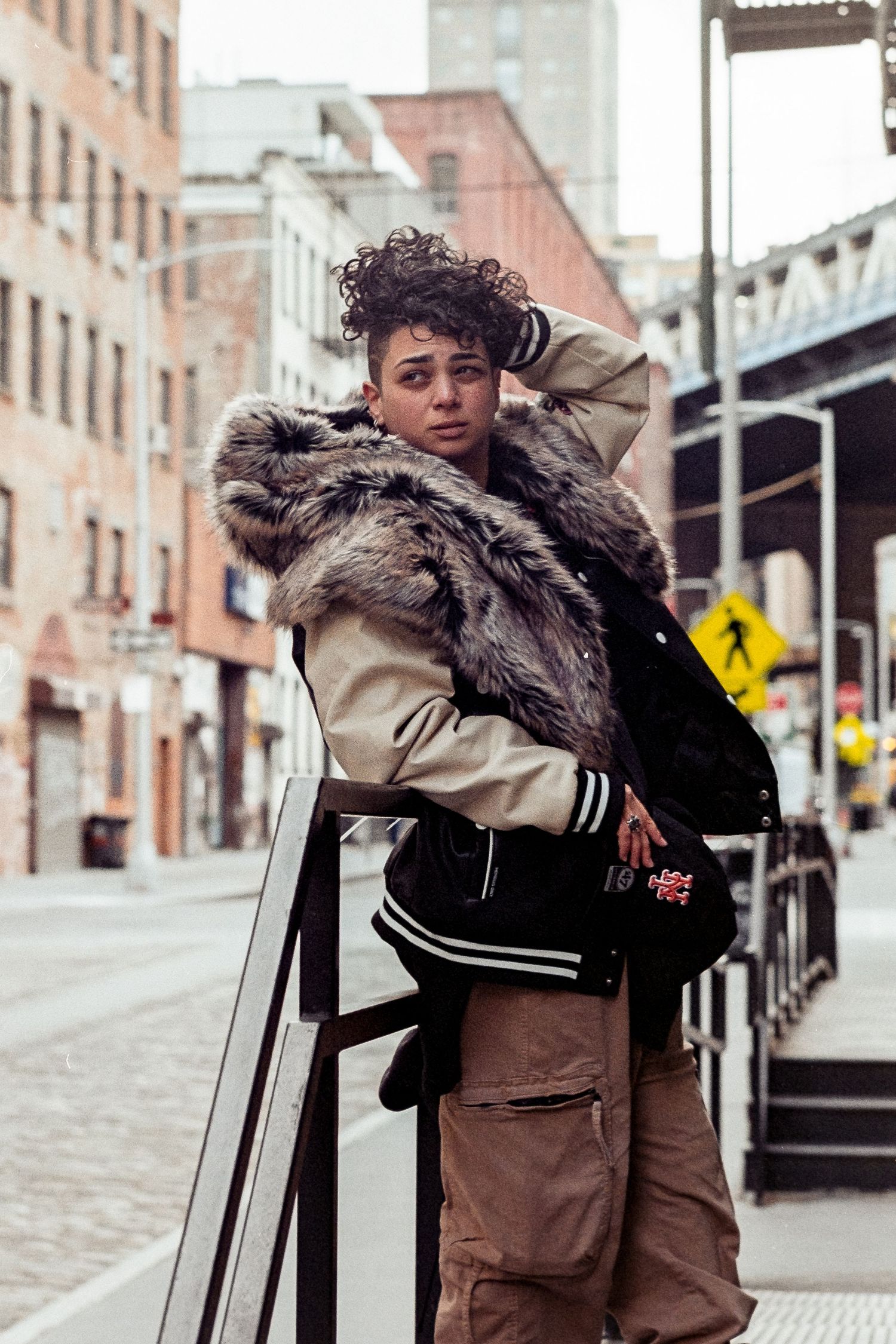 Woman posing and fixing her hair in DUMBO, Brooklyn
