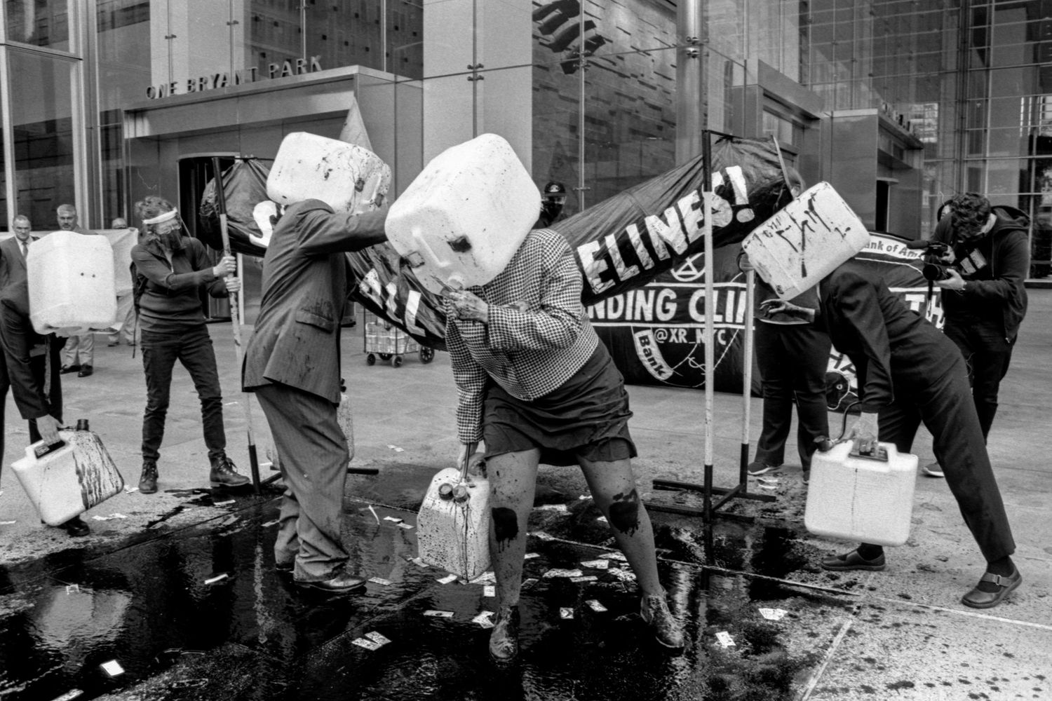 Climate demonstrators in front of a bank protesting oil