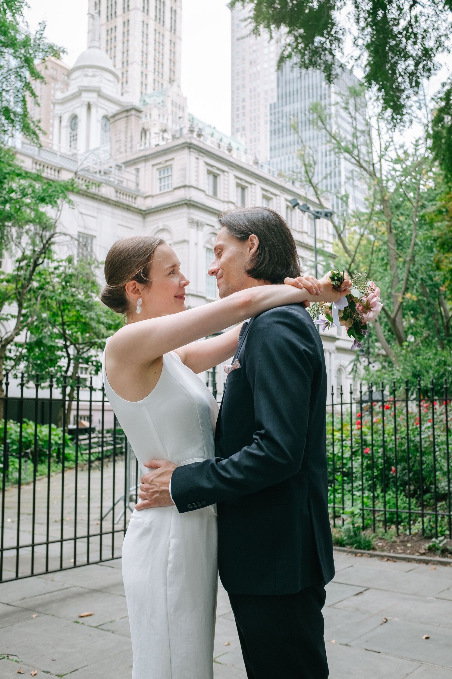 Recently married man and woman standing in front of City Hall, Manhattan