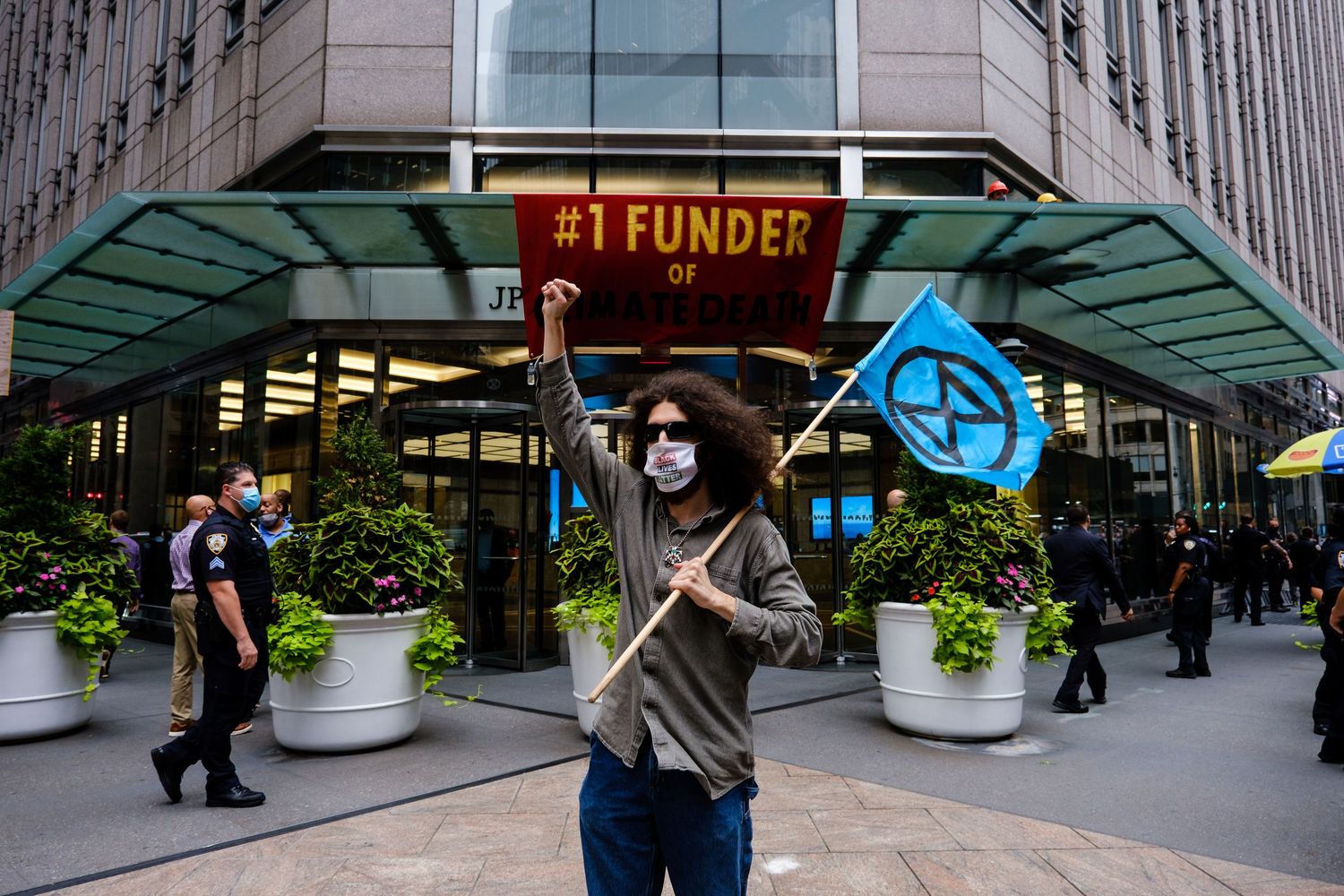 Man holding a flag in protest of Chase Bank