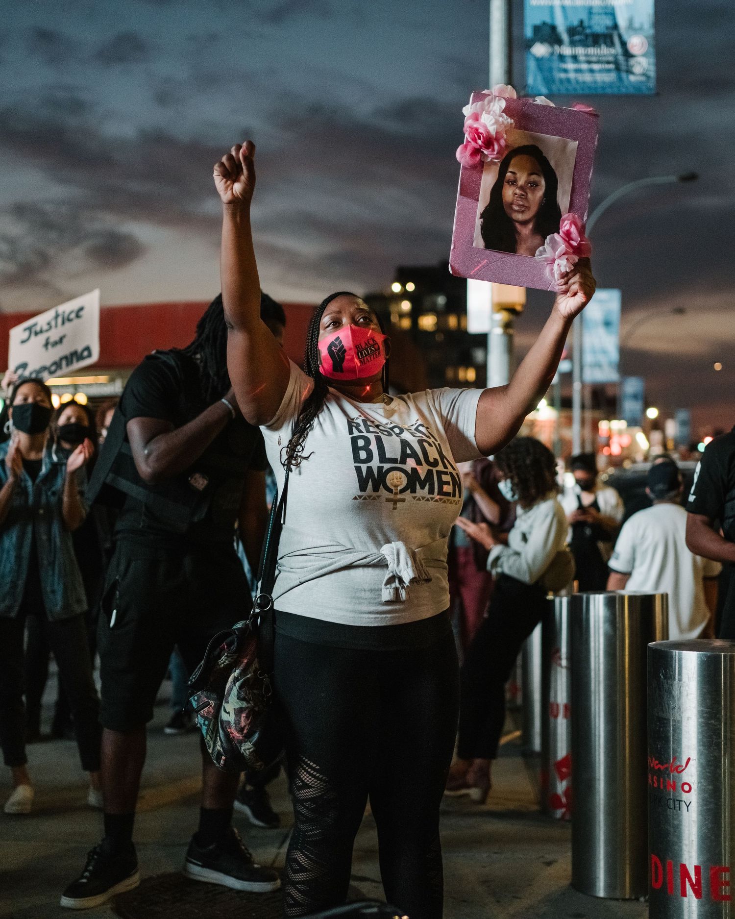 Black woman with raised fist in support of the memory of Breonna Taylor