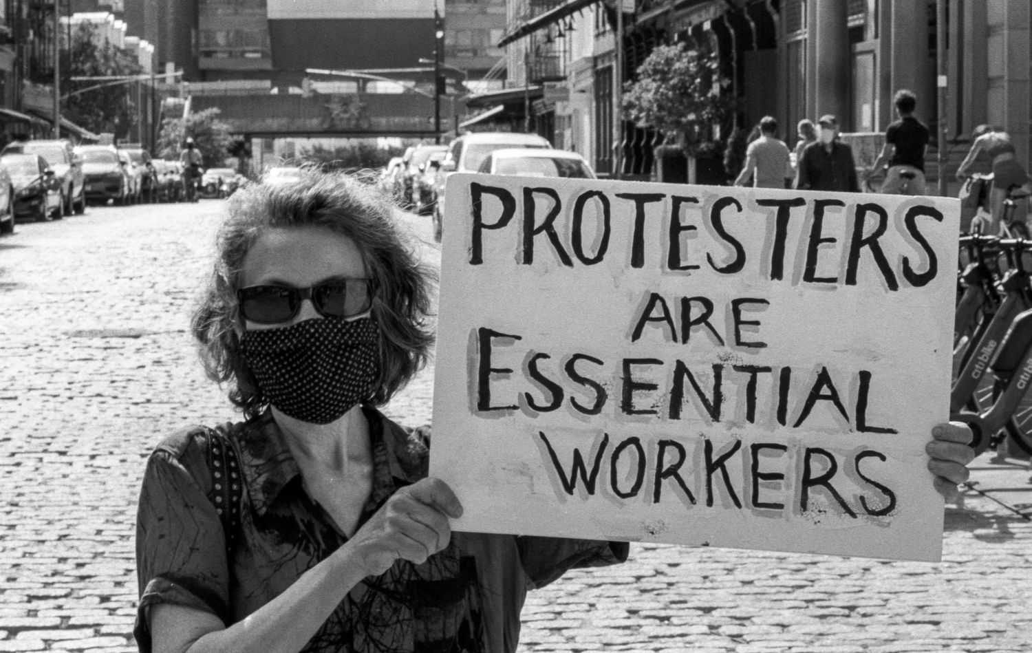 Woman holding a sign in support of protestors