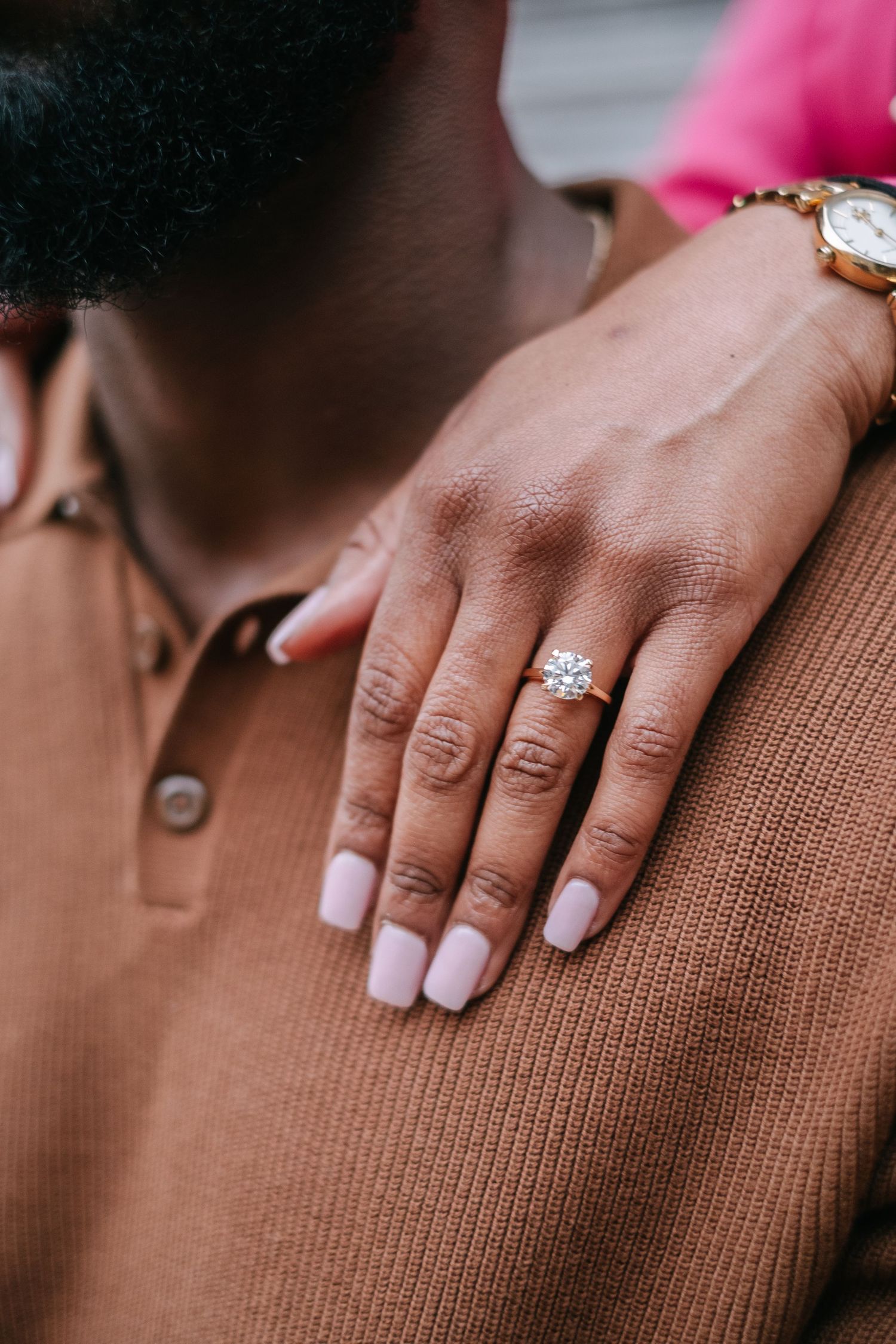 Recently engaged couple on The High Line in New York City with a close up of her ring