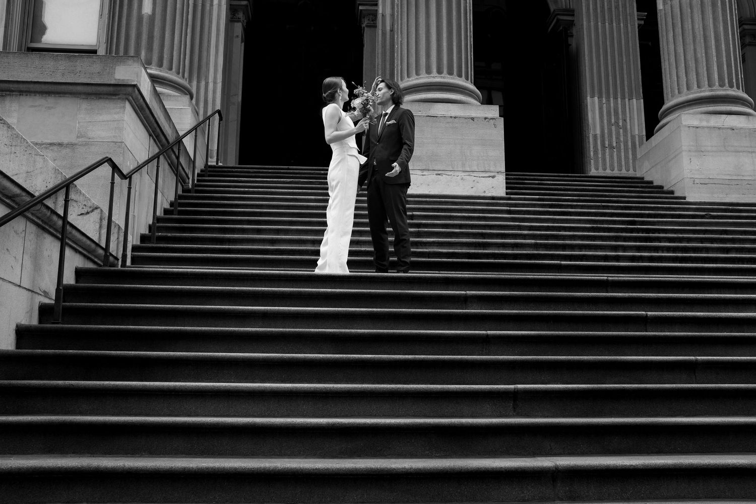 A couple standing on the stairs of a building in New York City