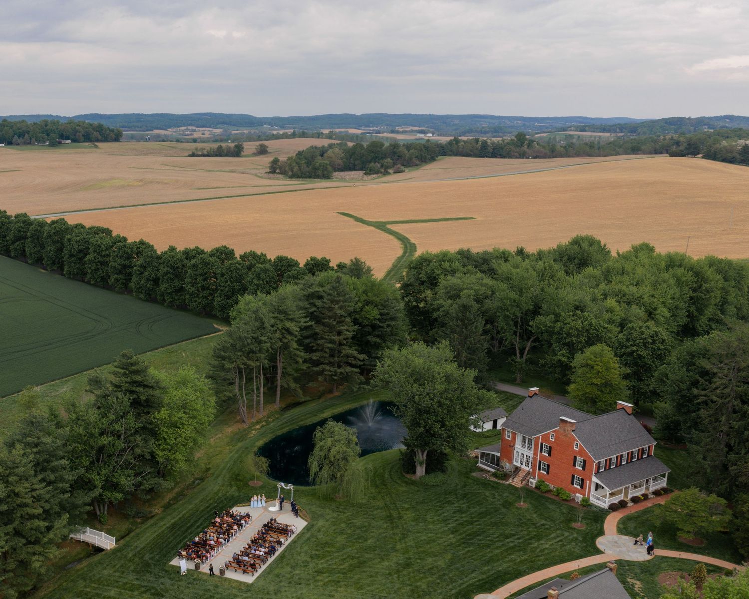 Drone view of an outdoor wedding ceremony at Christian Royer House in Westminster, Maryland