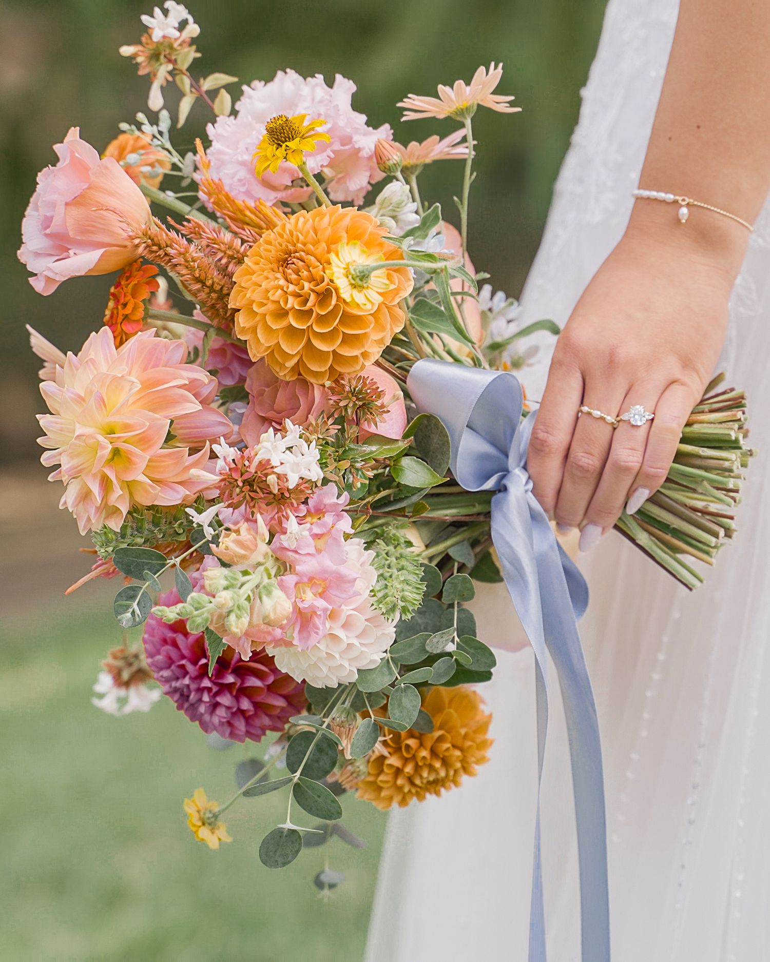 Bride holding an elegant floral bouquet during a Maryland wedding detail moment