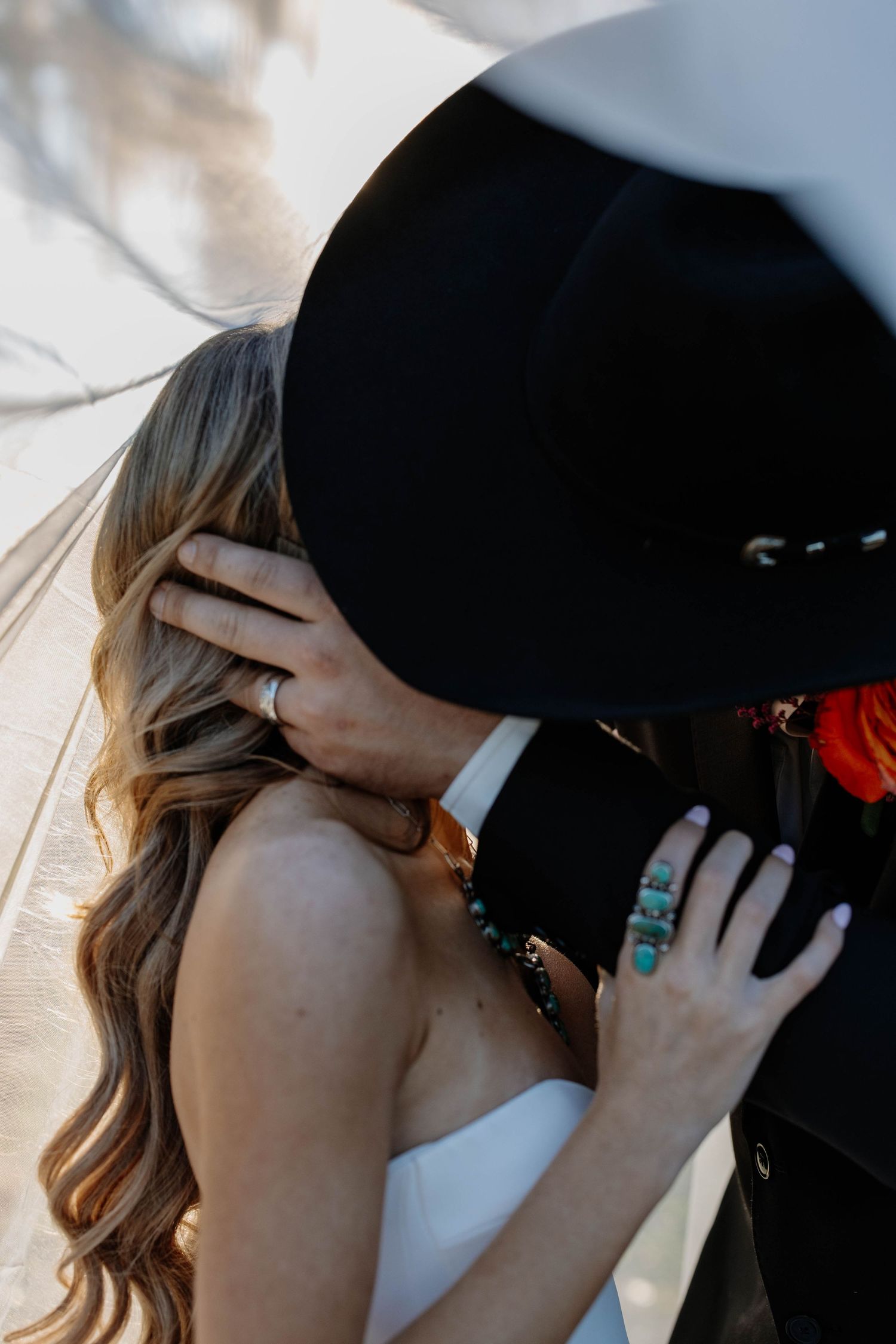 Close-up of romantic couple kissing with sunlight streaming through.