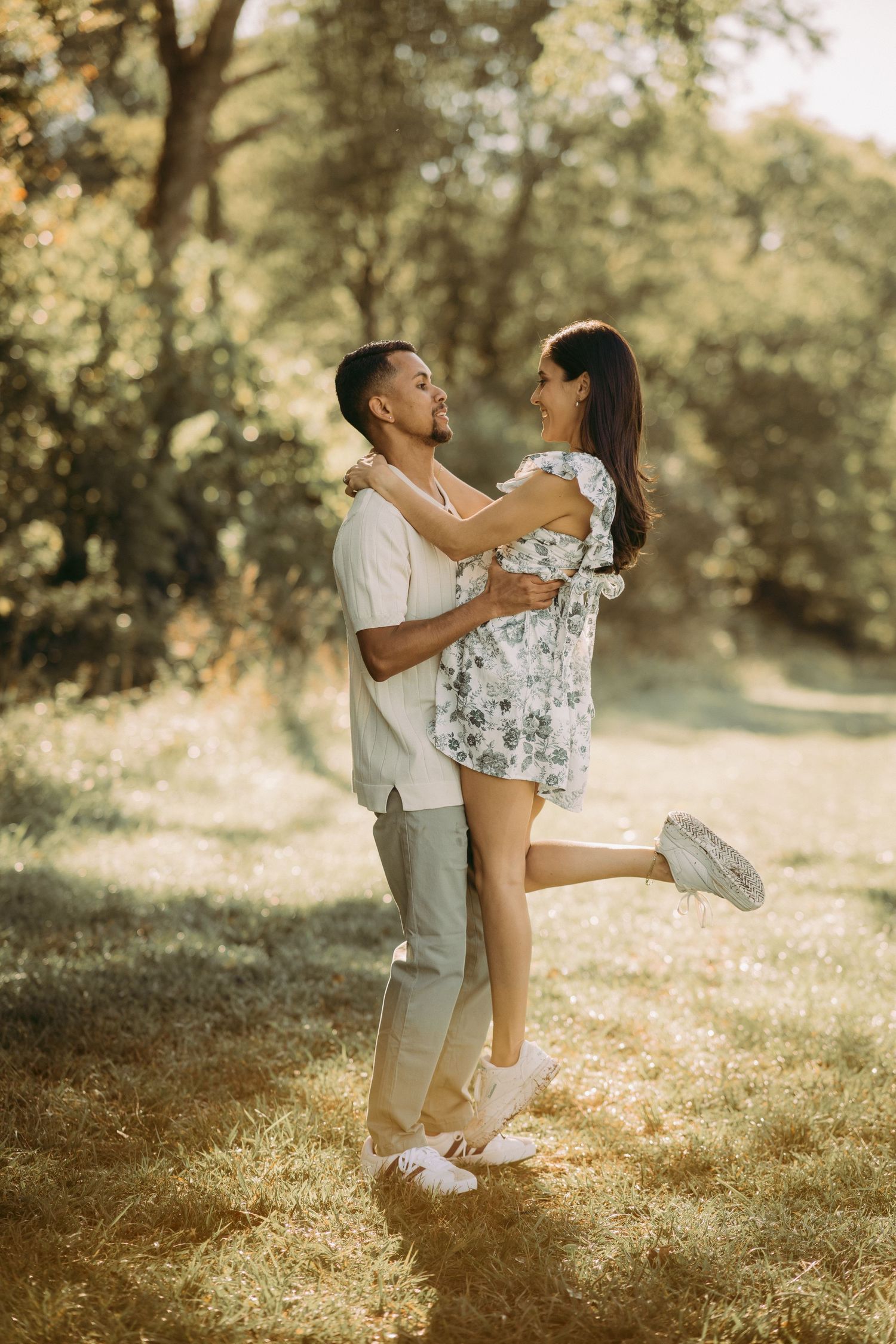 Outdoor engagement couple portrait in Manassas battlefield with puppy at golden hour