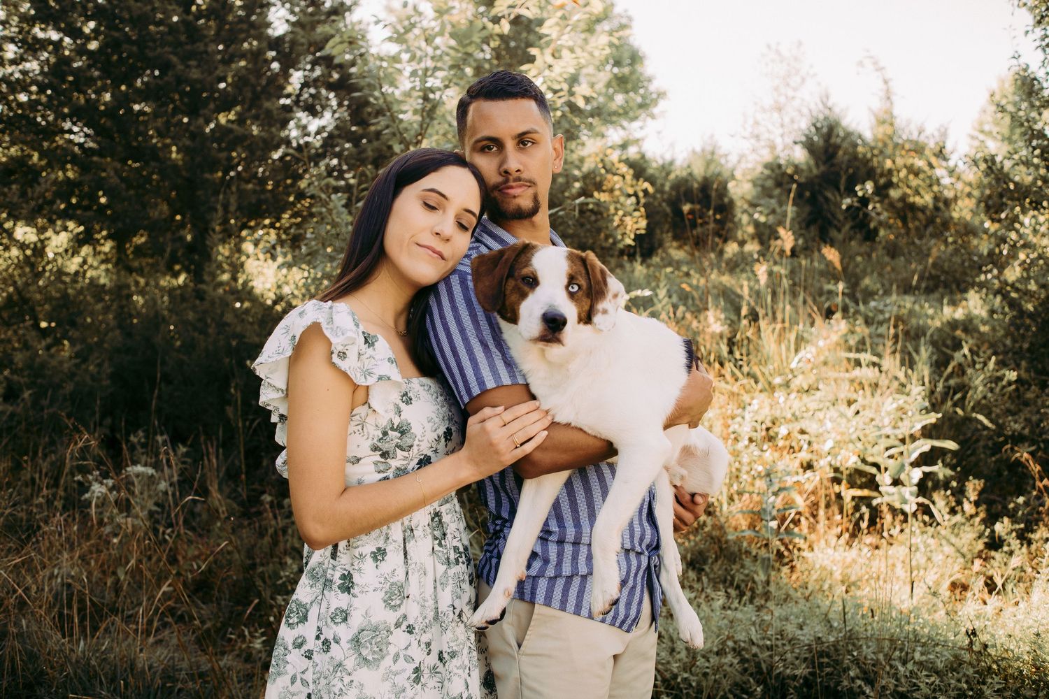 Outdoor engagement couple portrait in Manassas battlefield with puppy