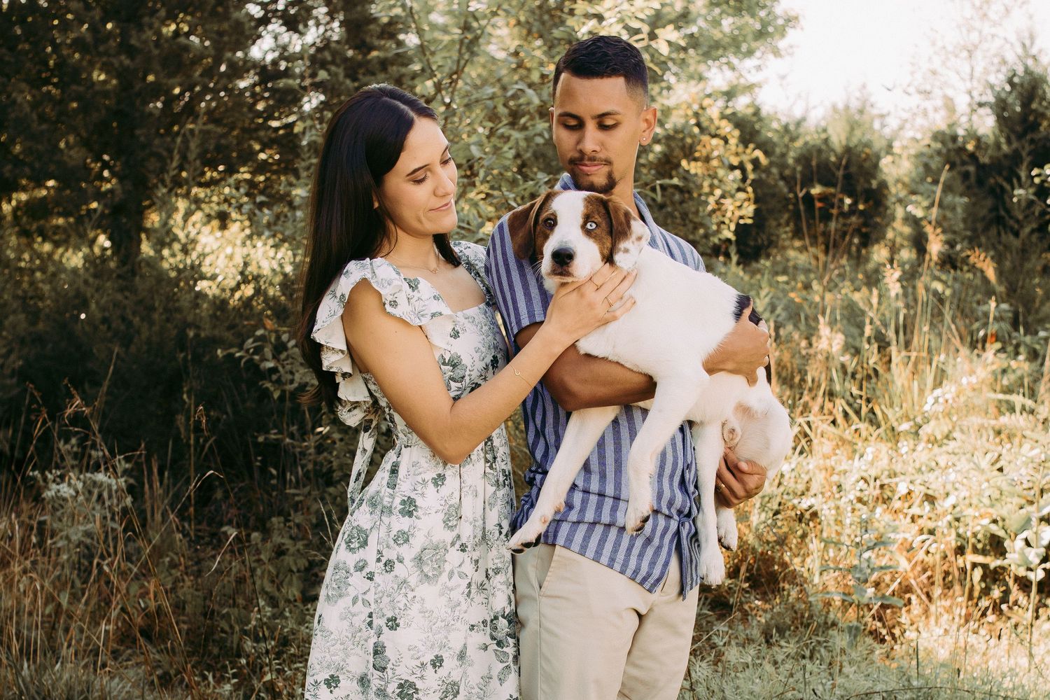 Outdoor engagement couple portrait in Manassas battlefield with puppy