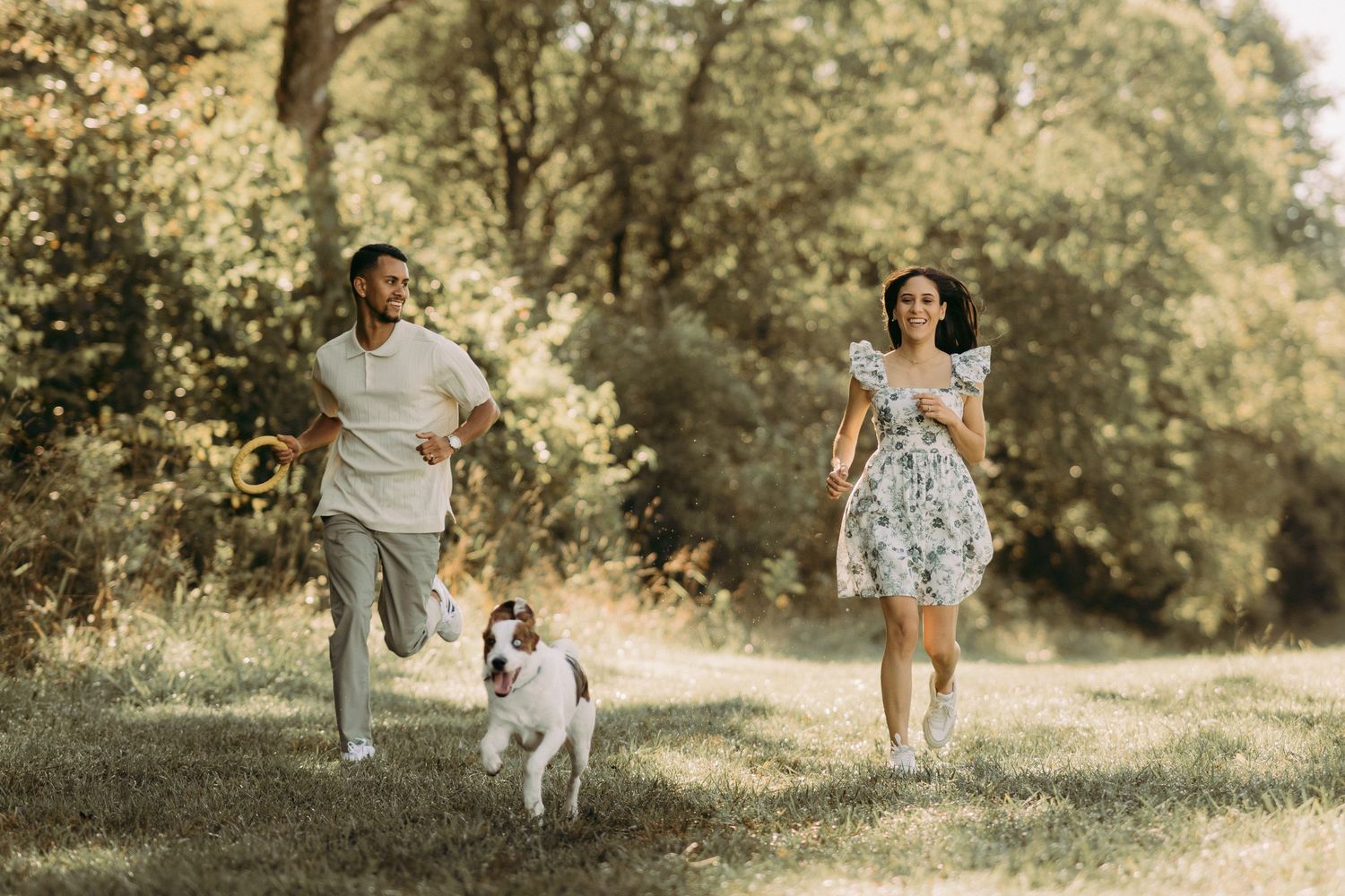 Outdoor engagement couple portrait in Manassas battlefield with puppy at golden hour