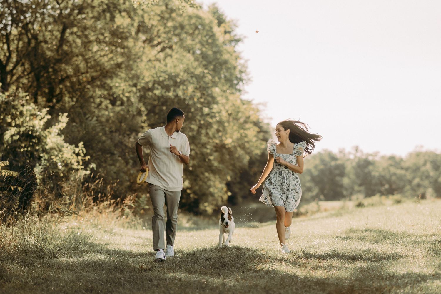 Outdoor engagement couple portrait in Manassas battlefield with puppy