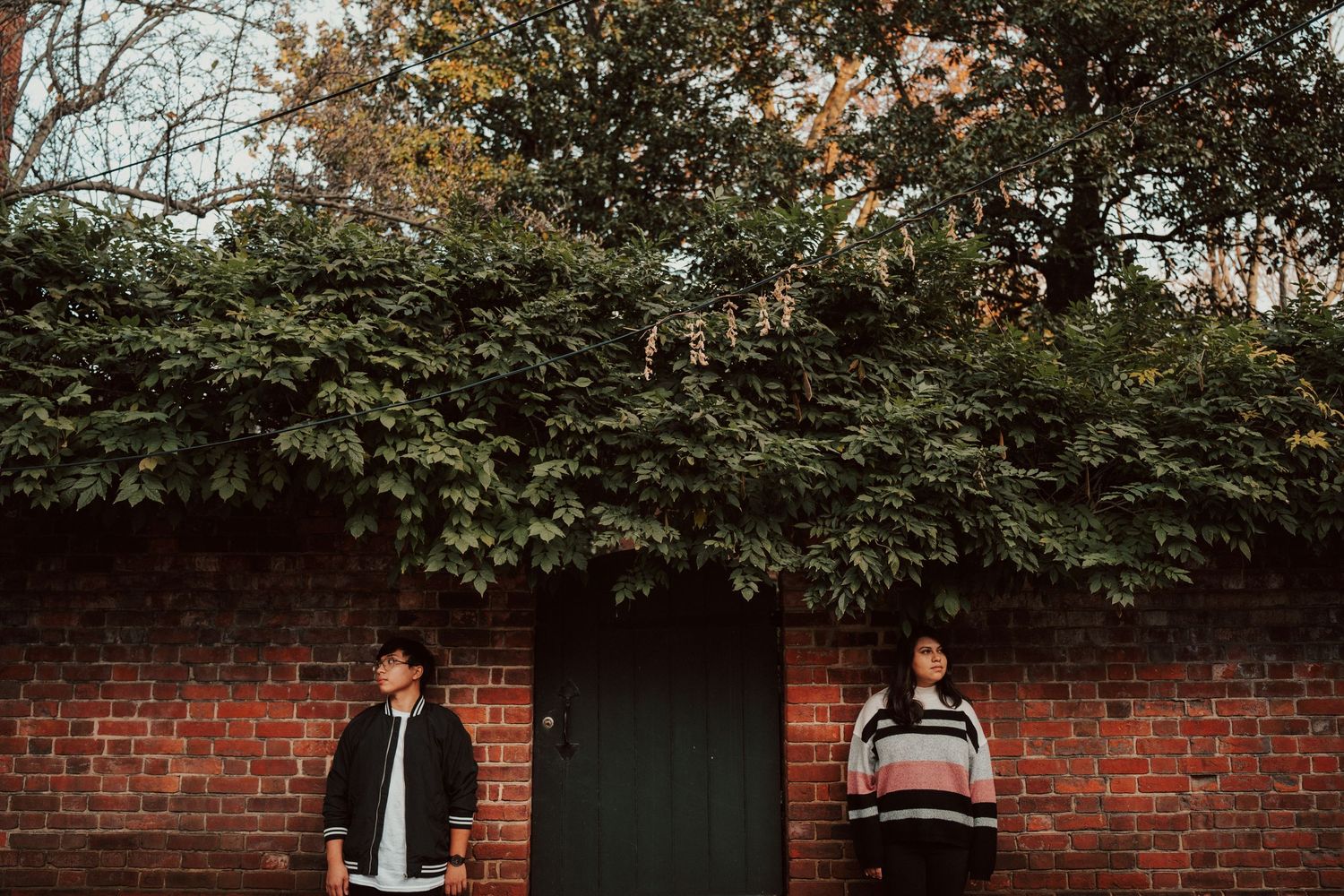 A series of connected photos showing a red brick wall with greenery and people in an outdoor setting in Old town Alexandria