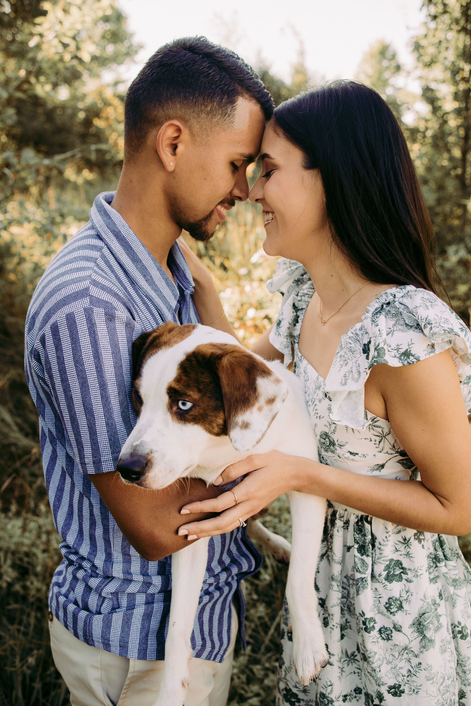 Outdoor engagement couple portrait in Manassas battlefield with puppy
