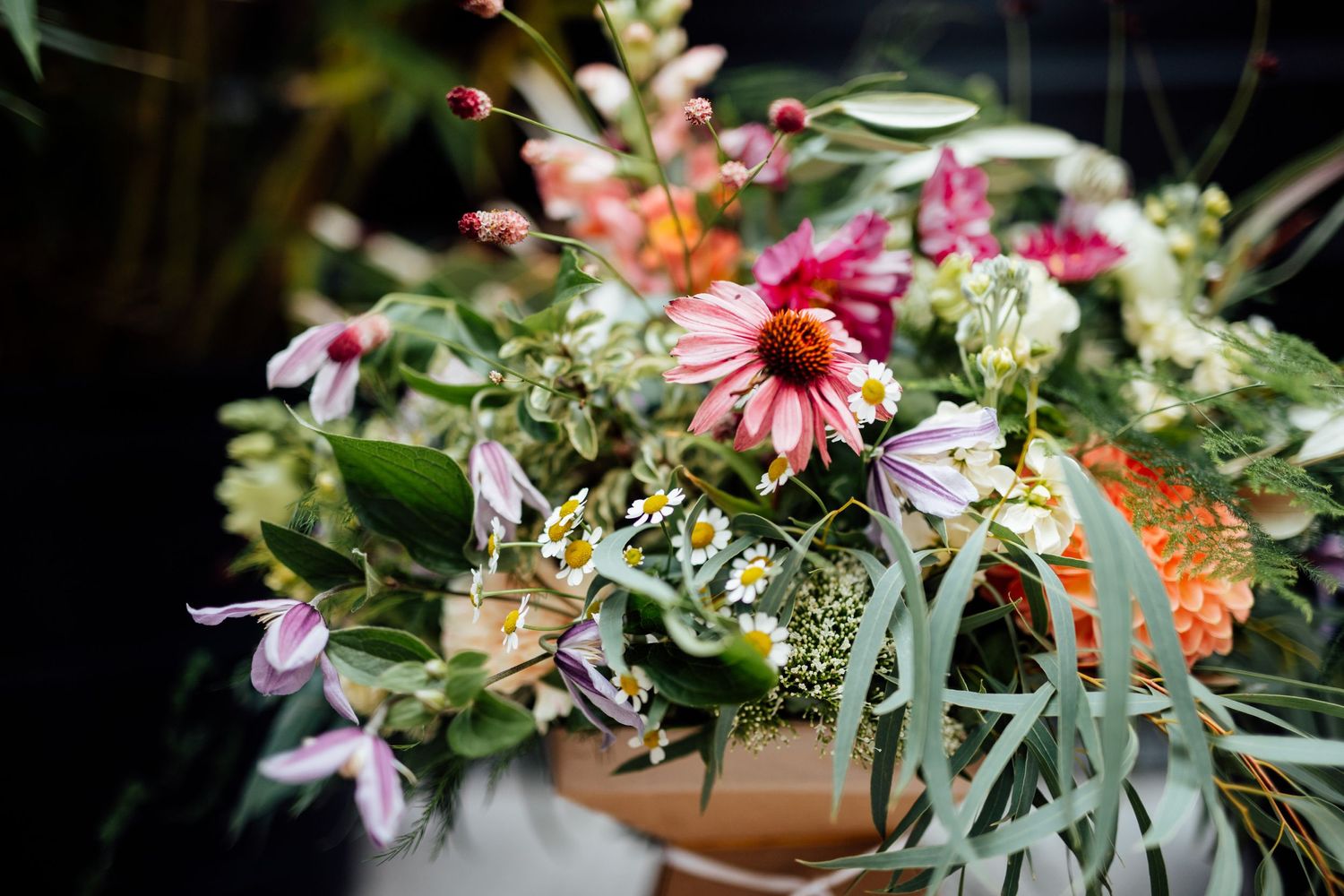 Vibrant floral arrangements with pink and purple blooms mixed with eucalyptus greenery.