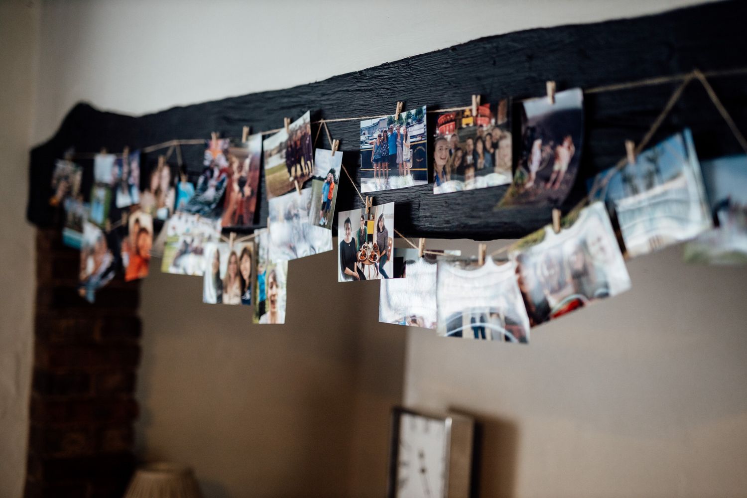 String of wedding photos hanging on display against a dark background.