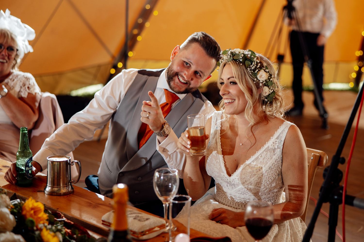 Joyful celebration moment at a wedding reception under warm lighting.