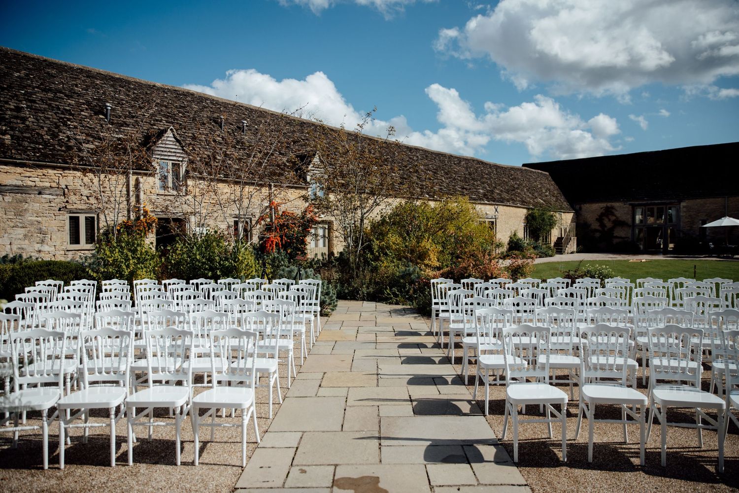 White chairs set up in rows for an outdoor wedding ceremony with mountain views.