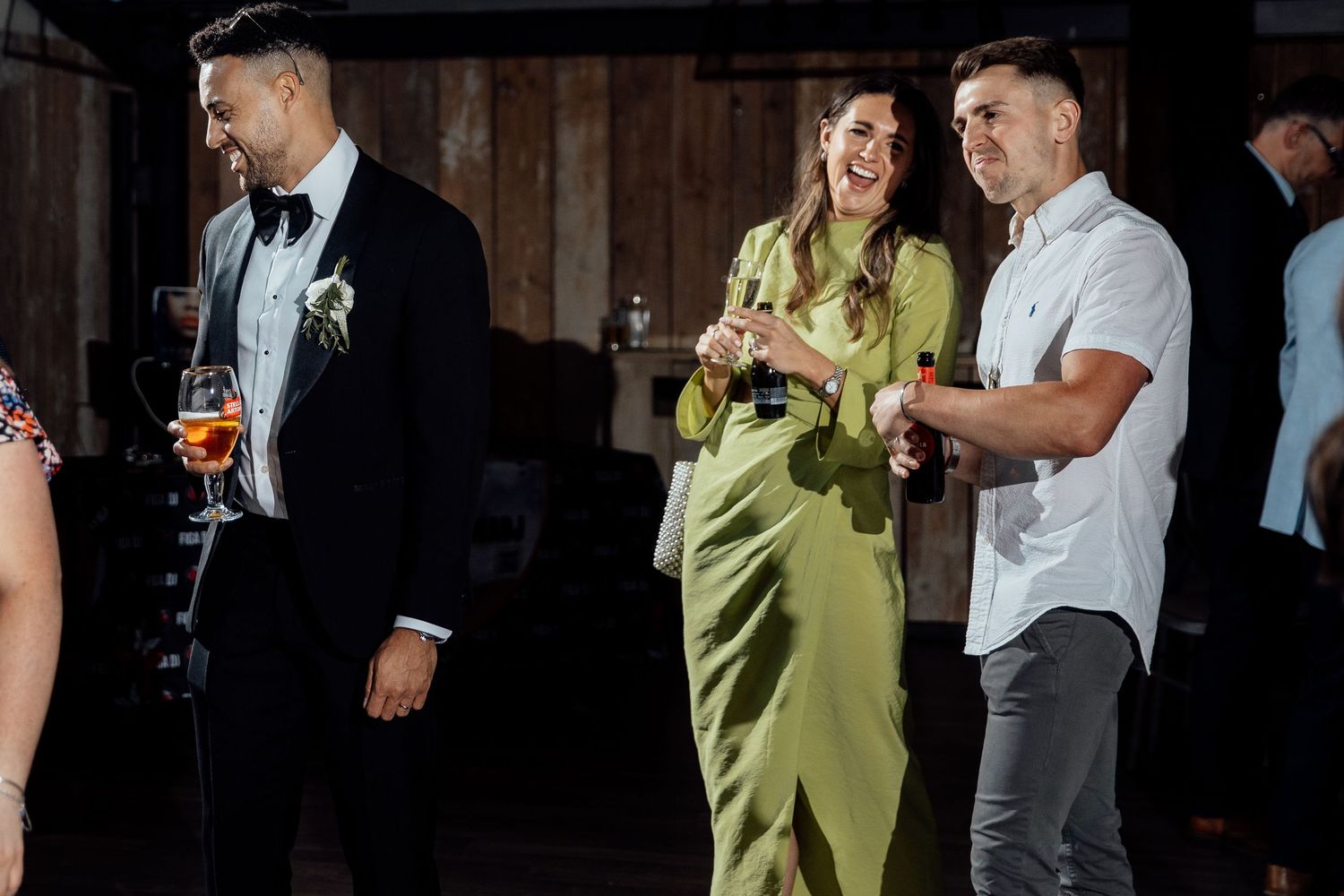 Wedding guests dance and celebrate during an evening reception party.