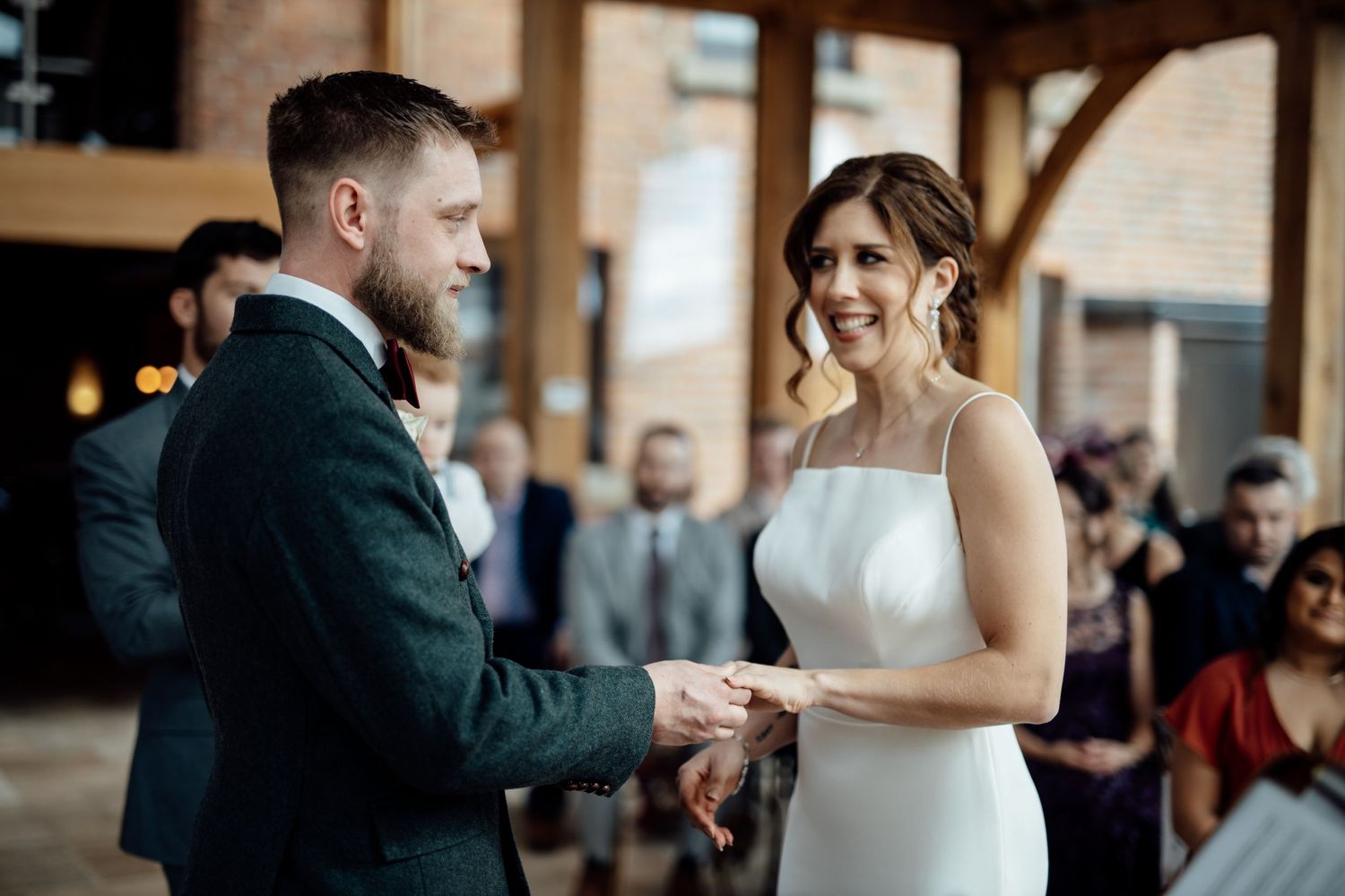 Wedding reception dancing scene in an elegant brick-walled venue.