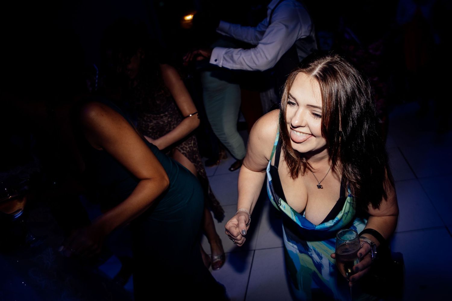 Dance floor filled with guests enjoying lively celebration at night.