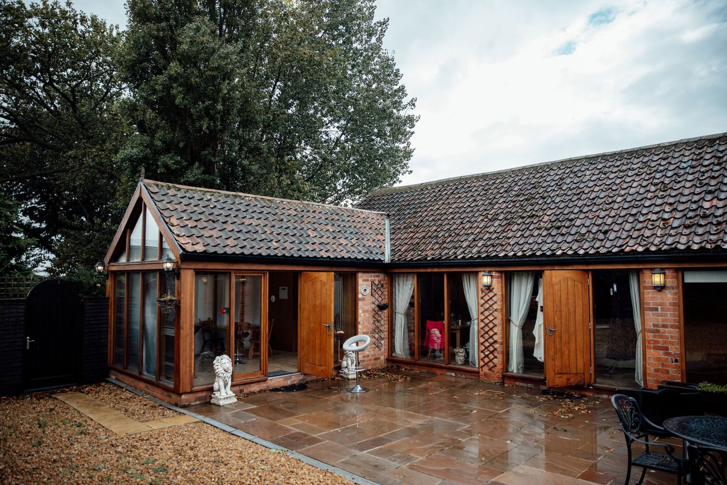 Exterior view of a rustic wooden wedding venue with traditional architecture.