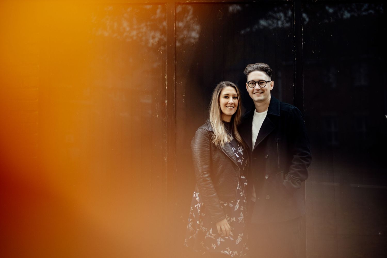 An intimate couple's portrait with warm golden bokeh lighting effects.