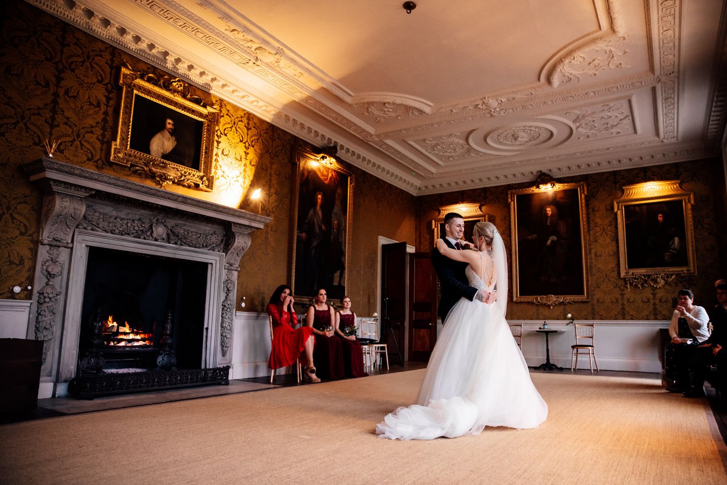 Elegant wedding venue interior with ornate details and warm lighting showcases multiple reception spaces.