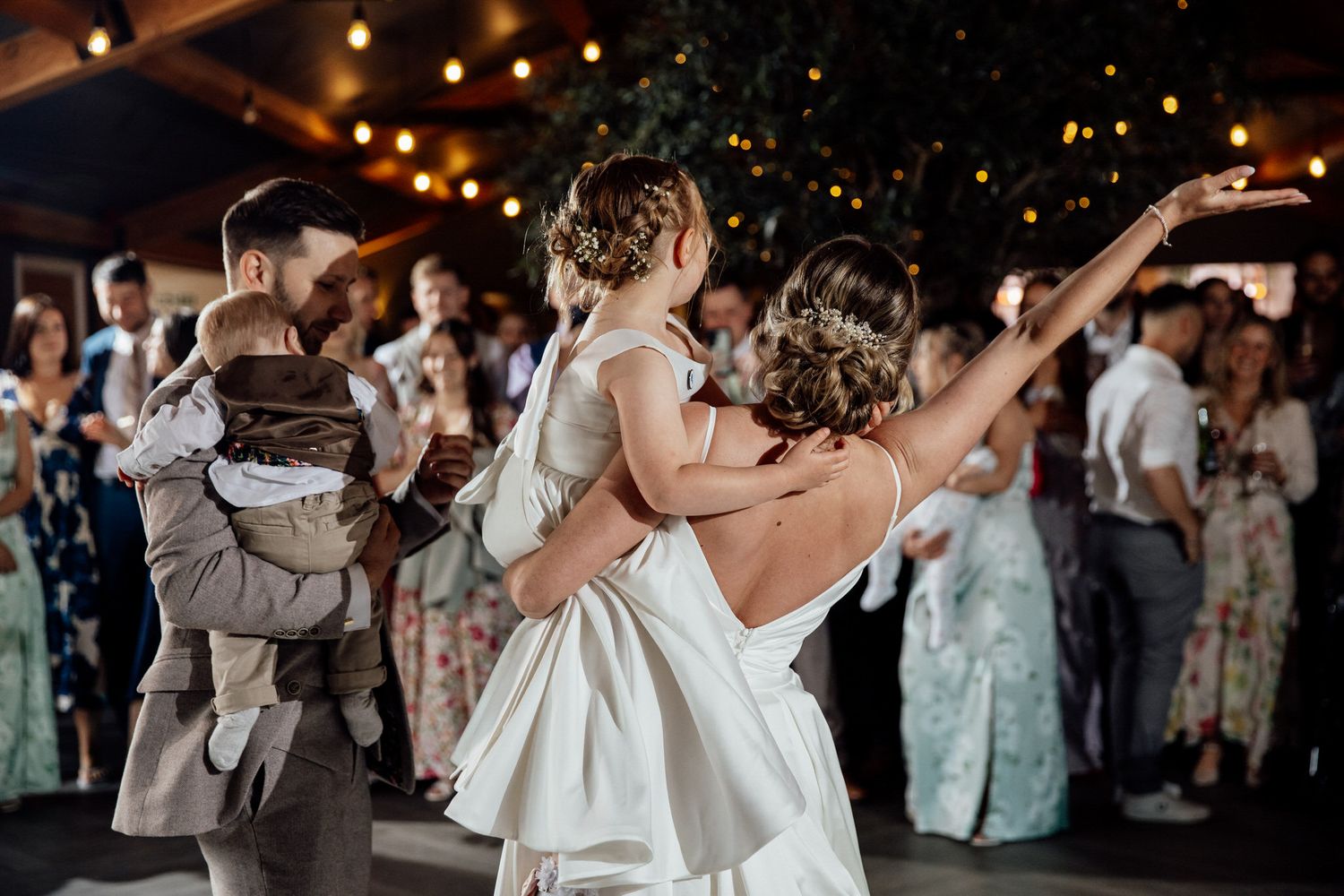 Wedding reception dance floor with string lights creating a festive atmosphere.