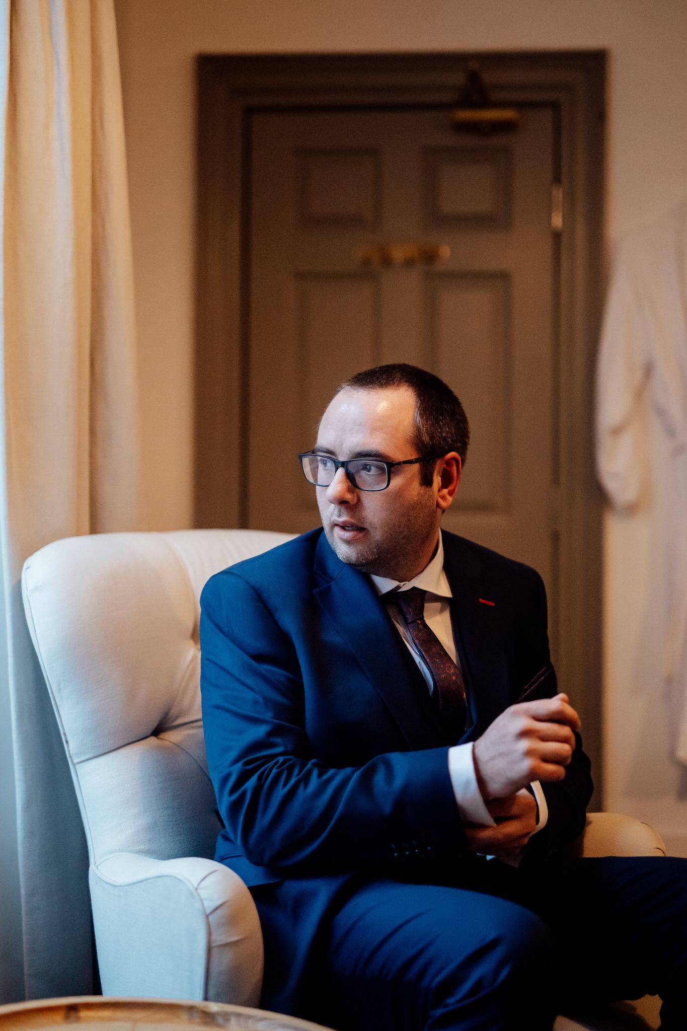 Wedding day preparations in elegant room with natural window light.