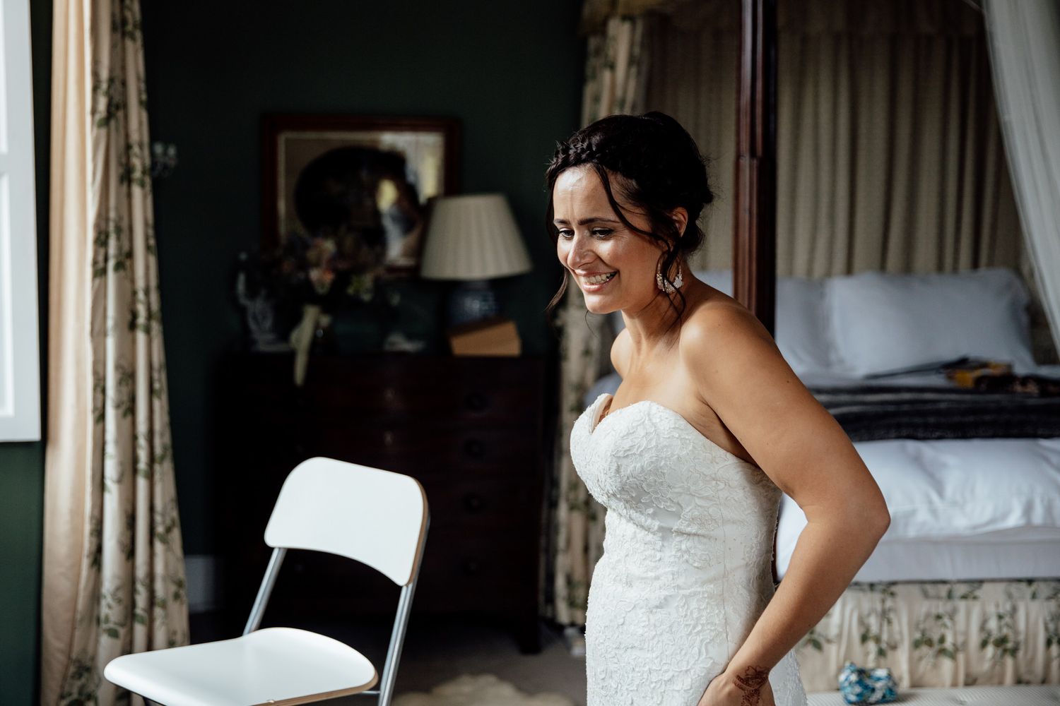 Getting ready scene in an elegant room with mint green walls and white curtains.