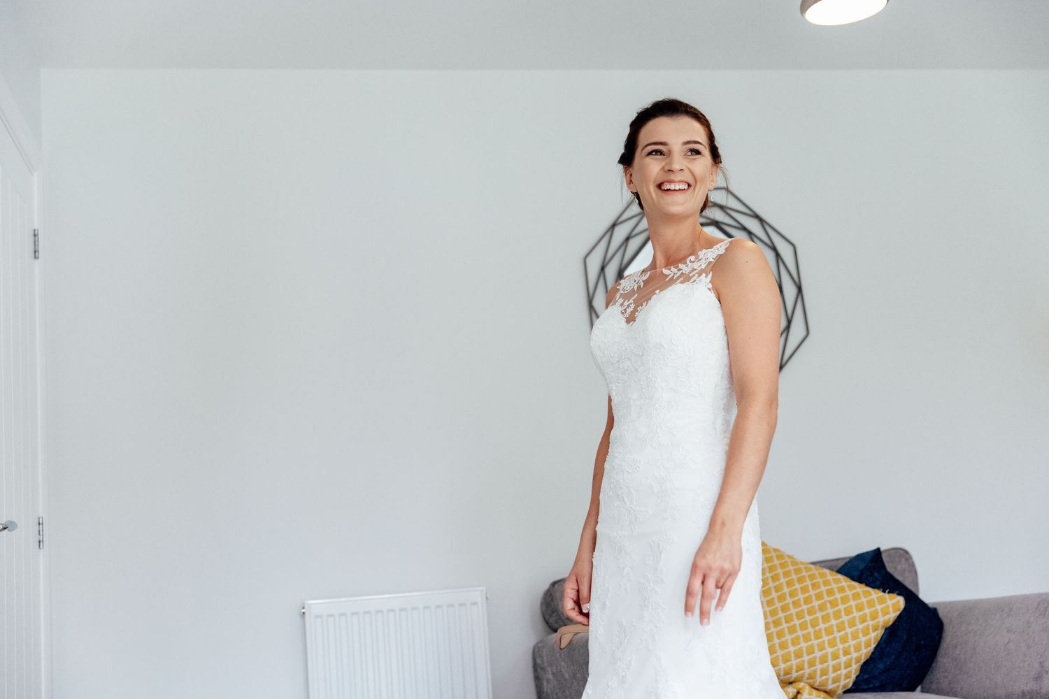 Bridal preparations taking place in a bright, modern white room.