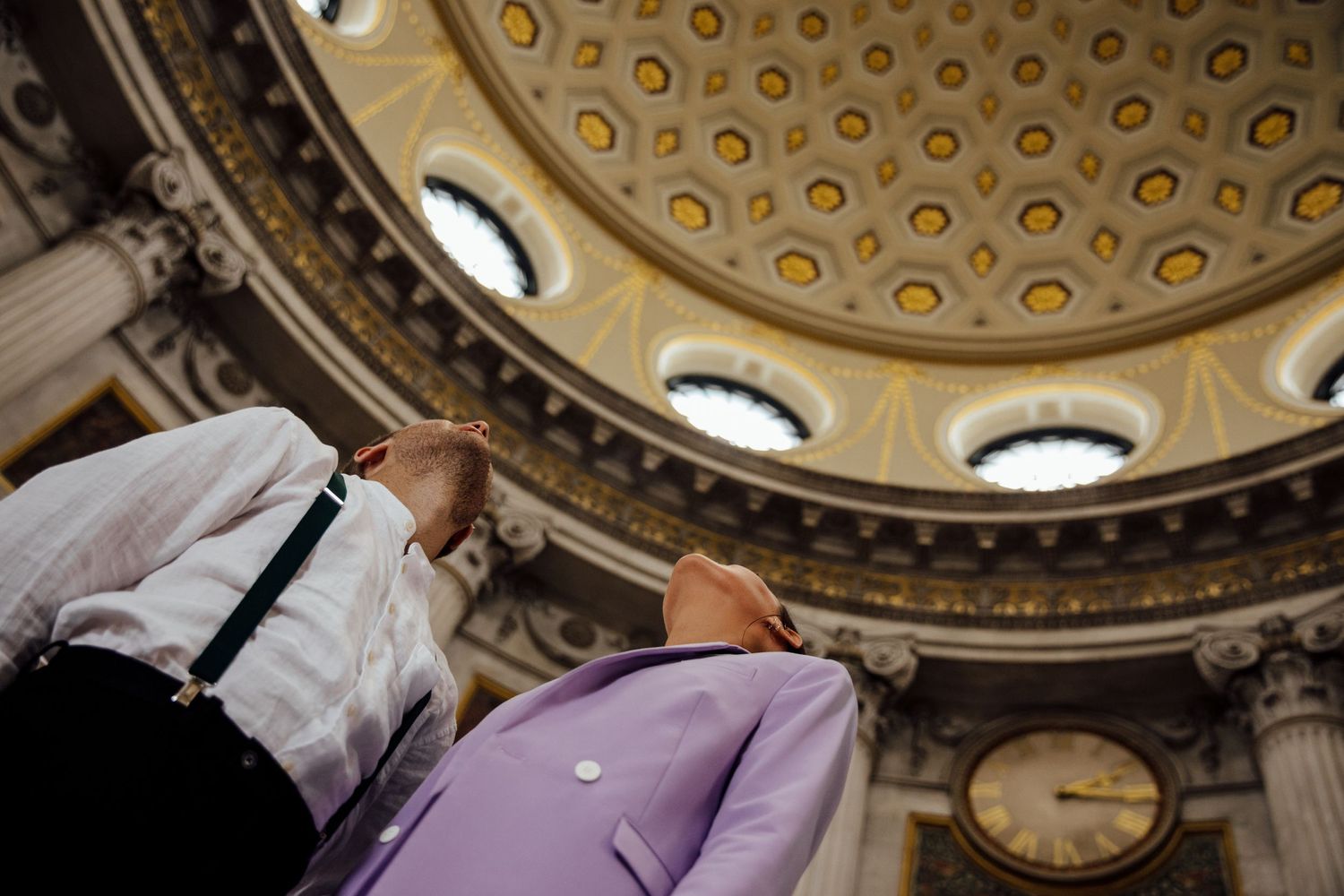 Ornate domed ceiling with circular pattern of gold accents and decorative molding.