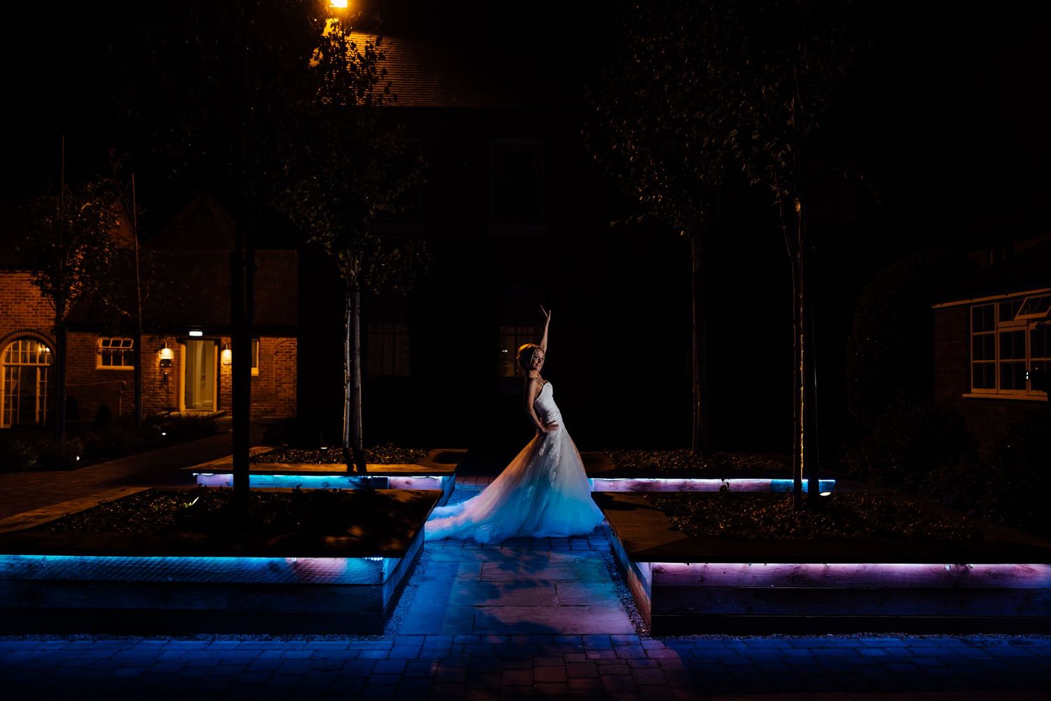 Nighttime exterior view of wedding venue with blue ambient lighting.