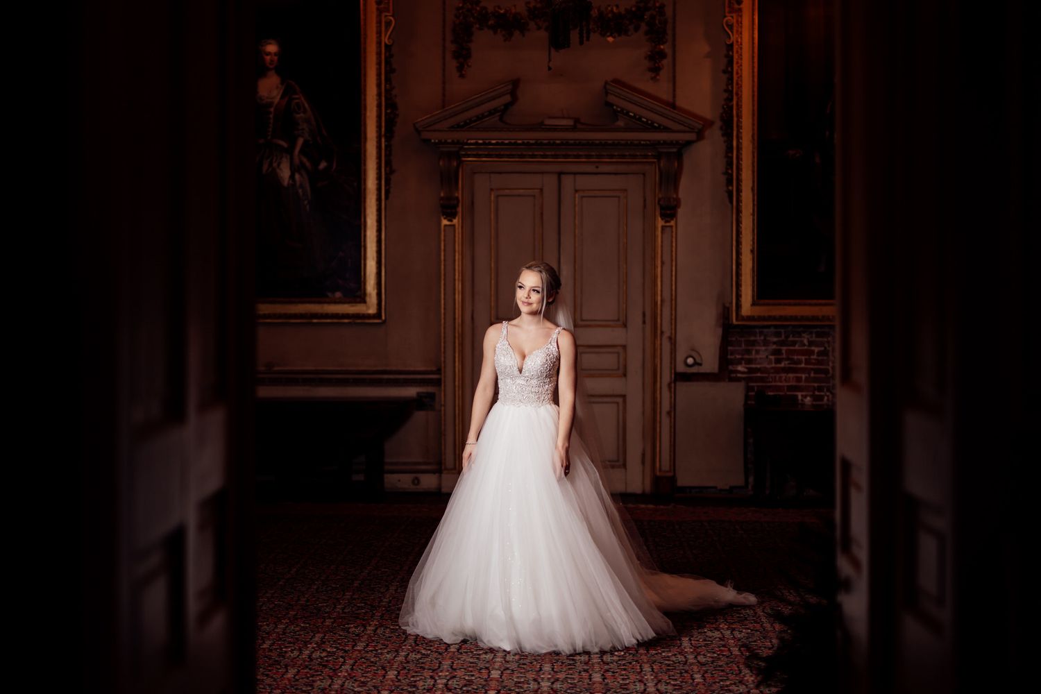 Elegant bridal portrait in historic venue with ornate architectural details.