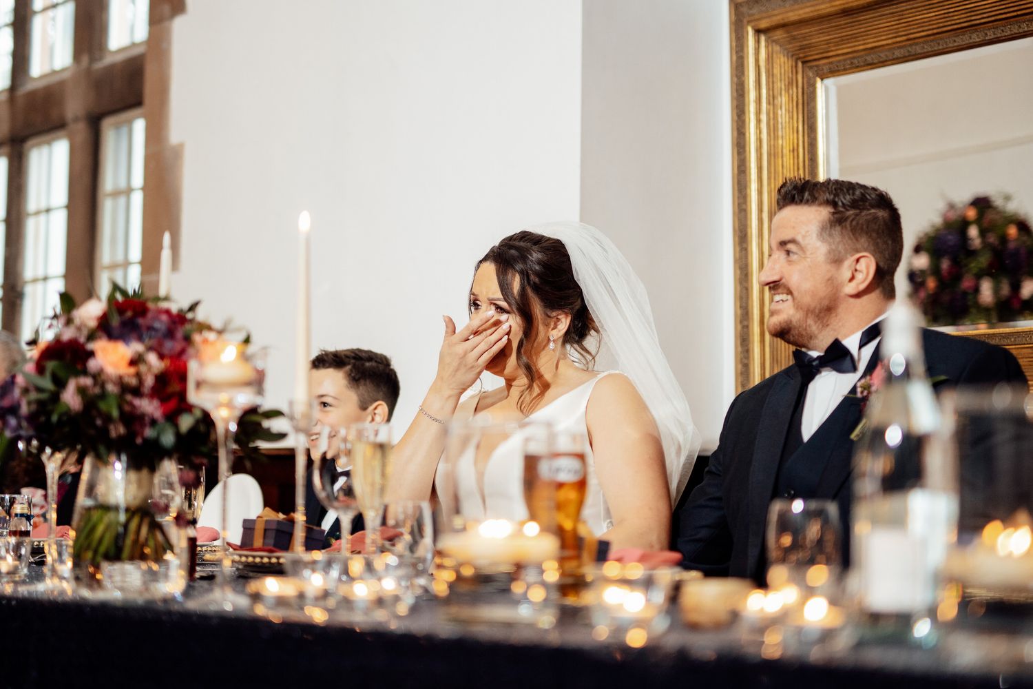 Wedding reception dinner table setting with elegant decor and candlelight.
