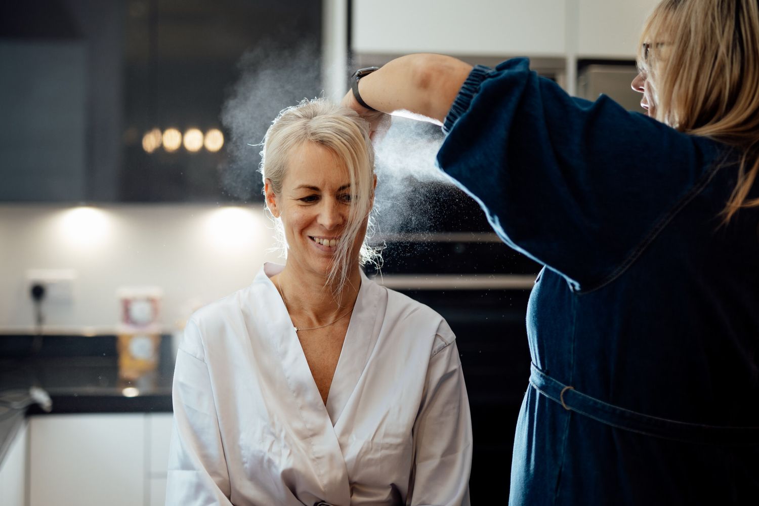 Wedding preparation moments captured in a bright, modern getting-ready room.