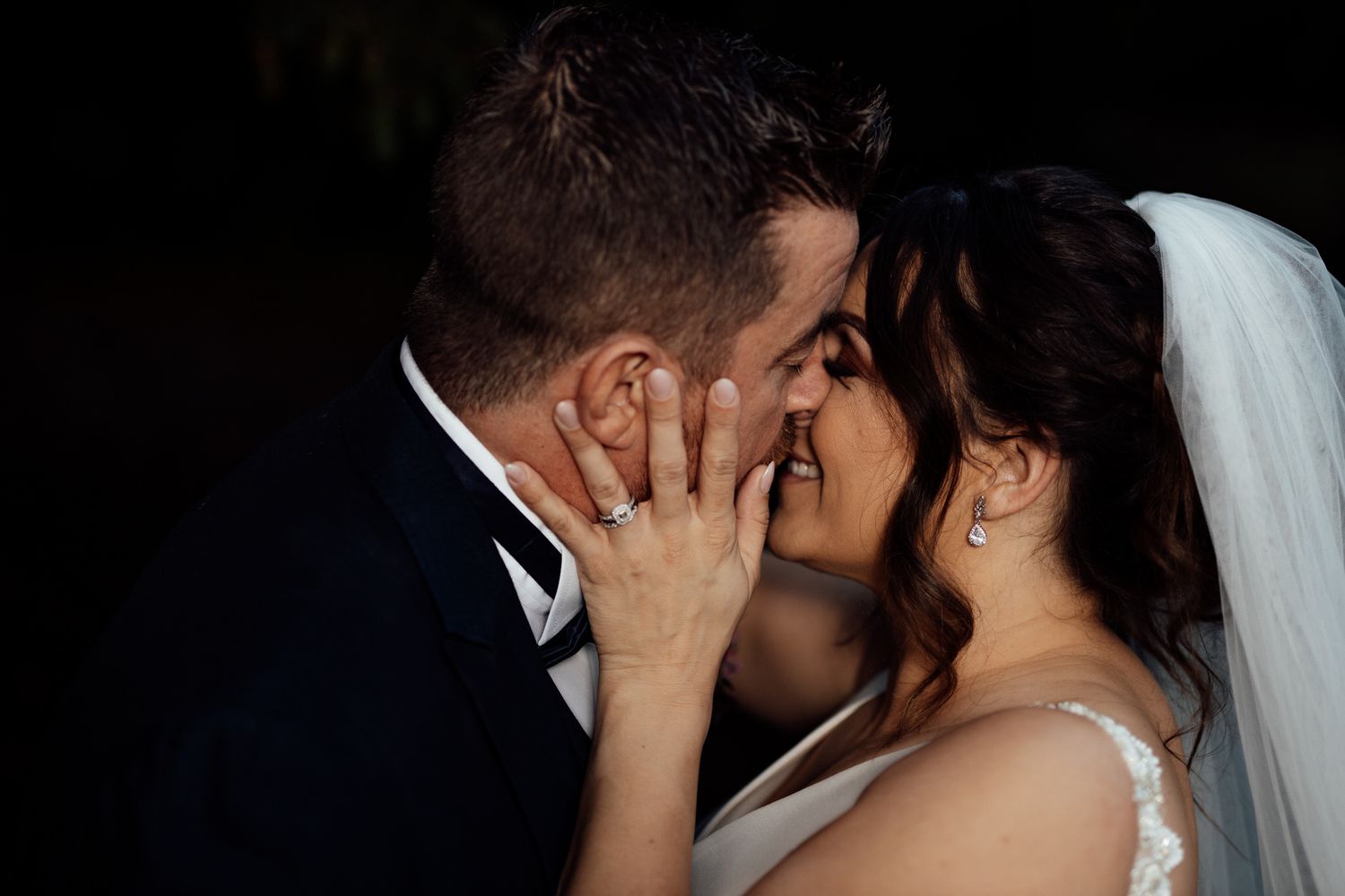 A romantic wedding couple shares an intimate moment during their outdoor autumn photo session.