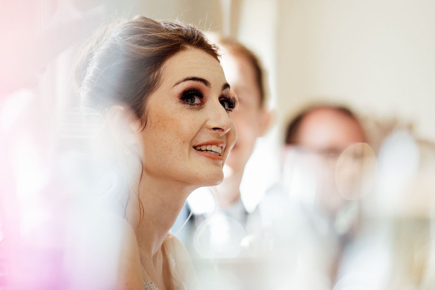 Soft focus wedding preparation moments in natural window light.