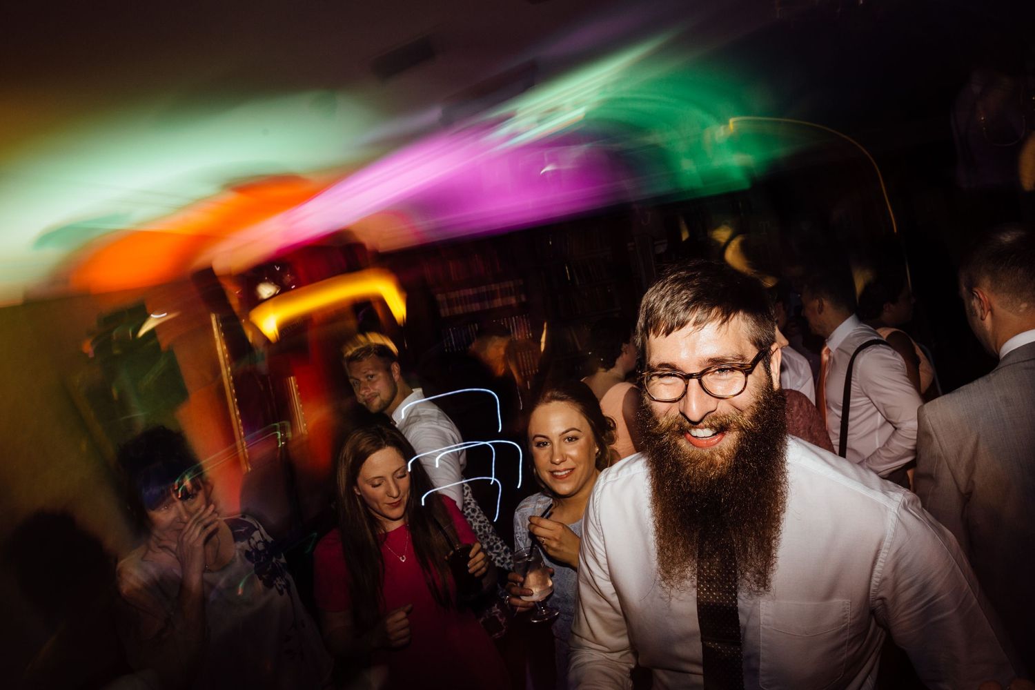Energetic dance party scene with dynamic lighting and movement.