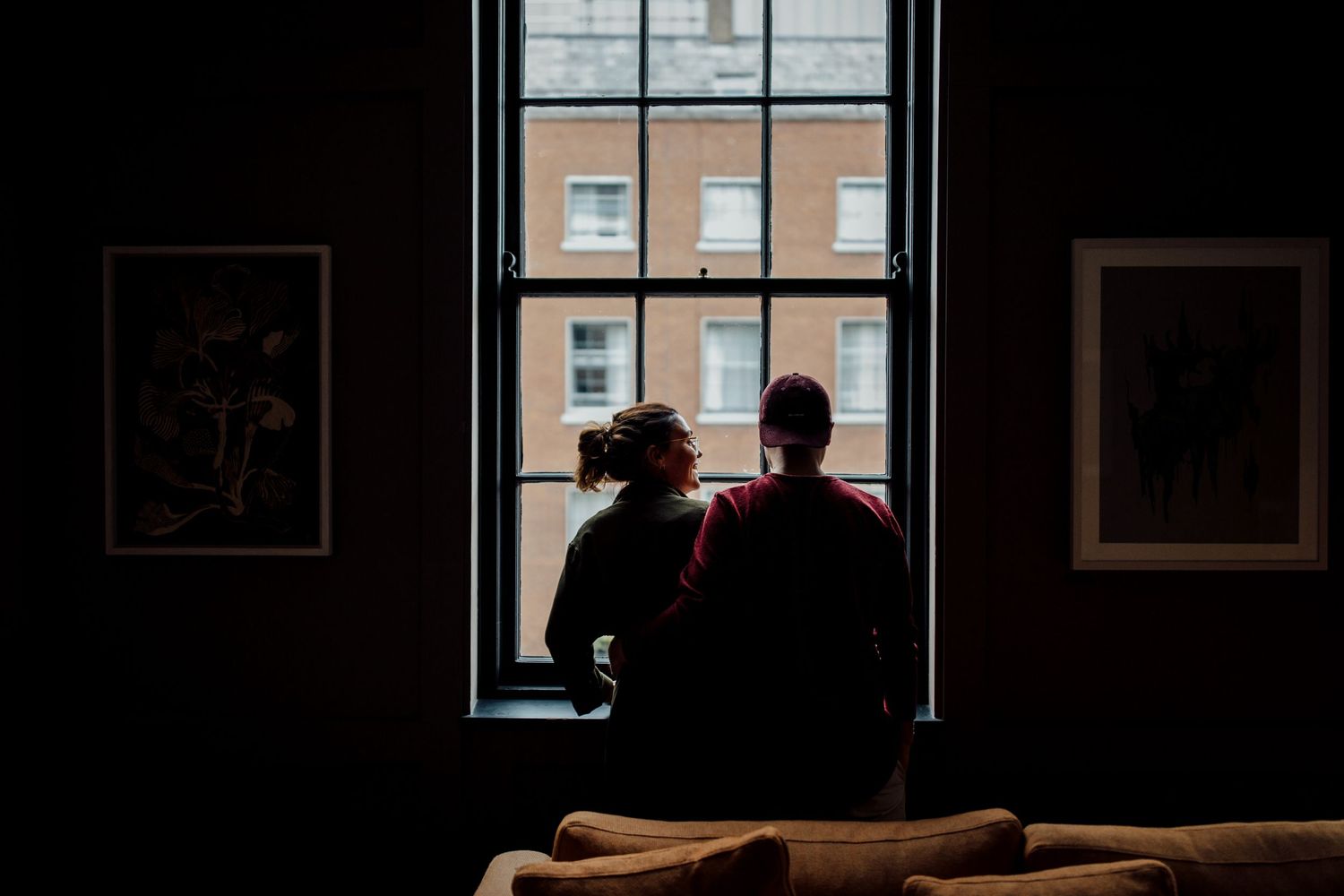 Dark interior room with bright windows creating silhouette effect.