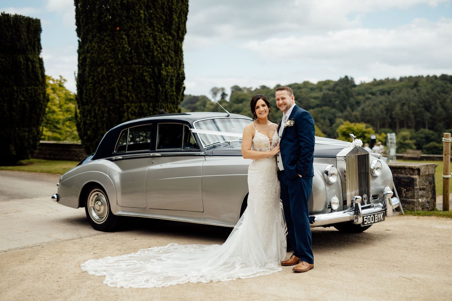 Classic vintage cars parked on display at an outdoor wedding venue.