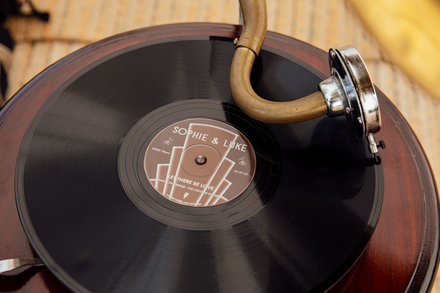 Vintage record player turntable with vinyl record playing at wedding reception.