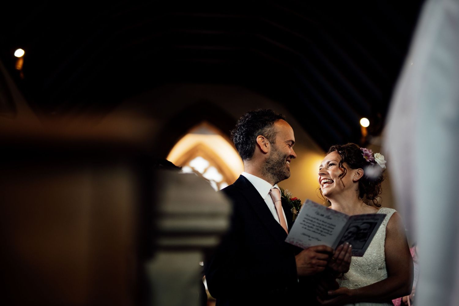 Romantic wedding moments captured in low-light with bokeh effects.